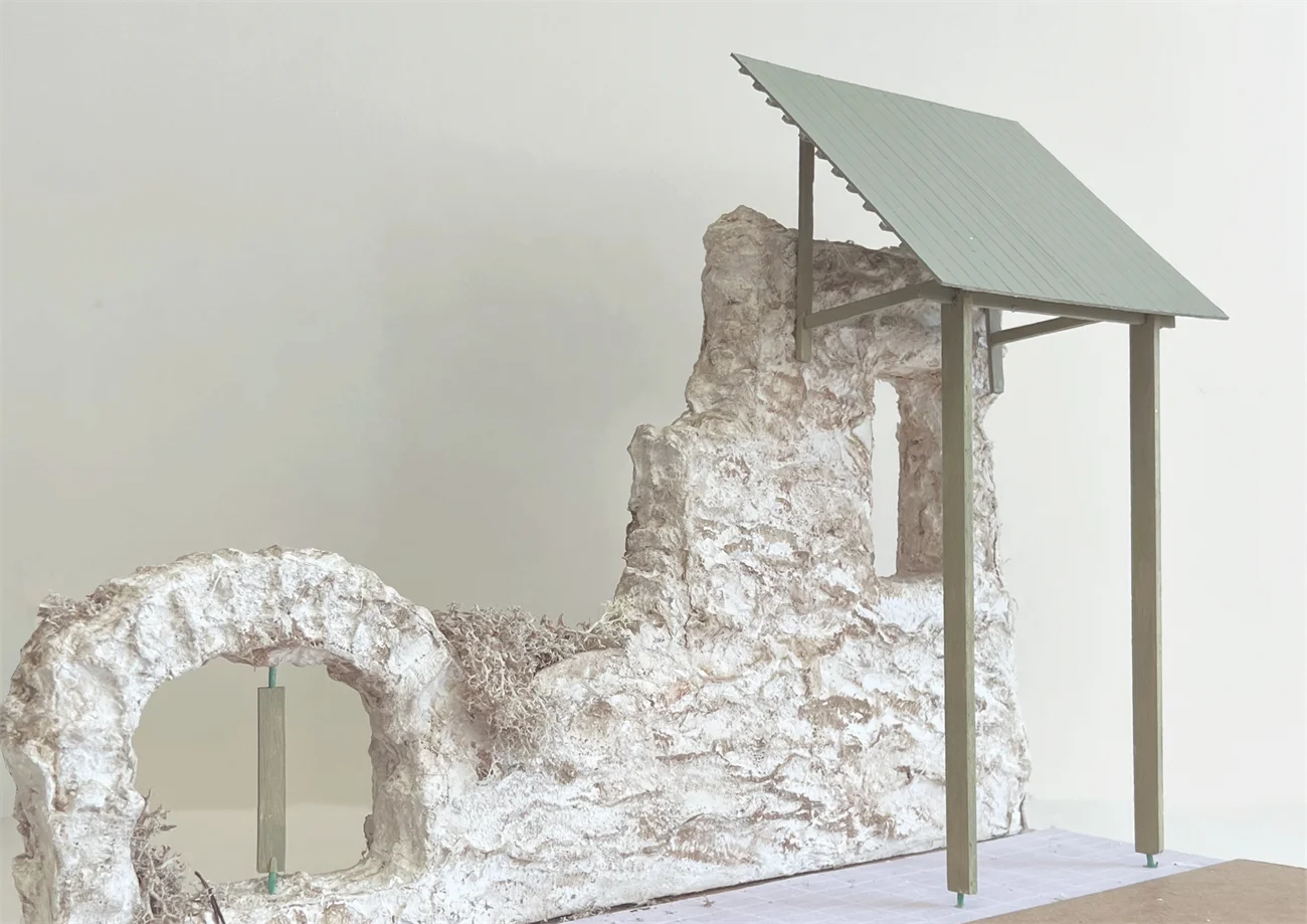 Timber canopy structure over stone ruin
